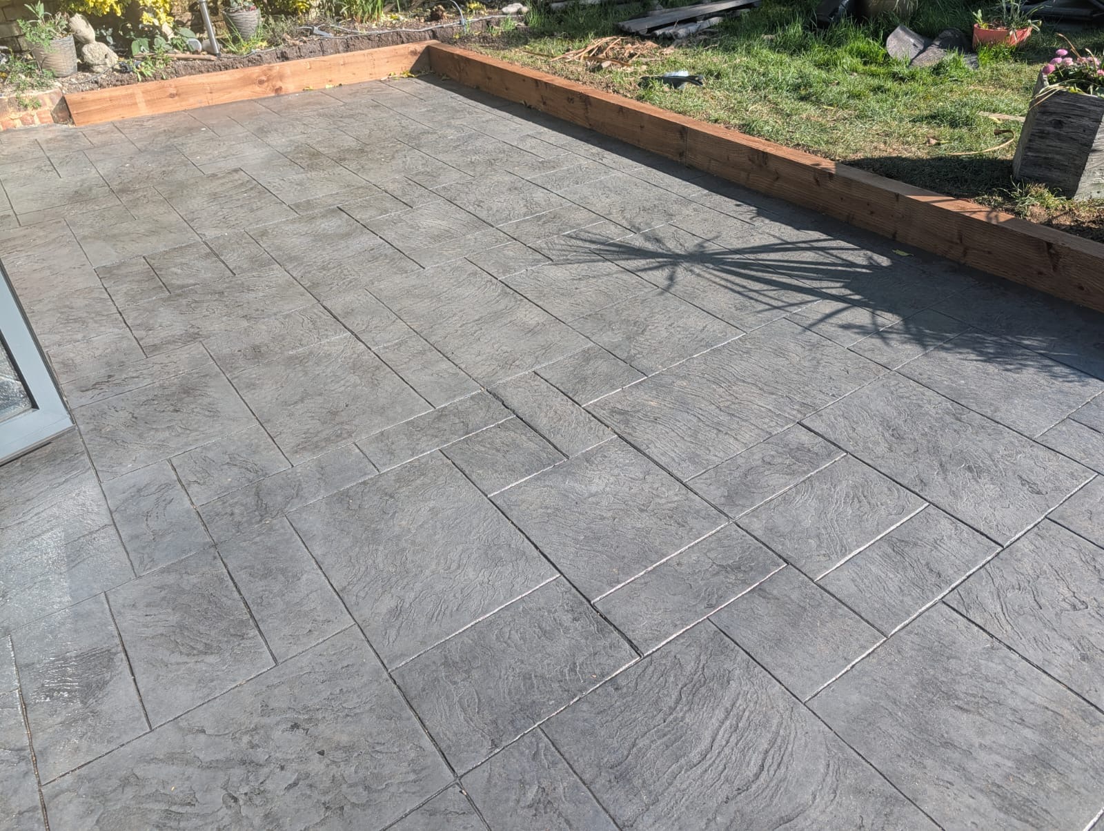 Grey slate pattern imprinted patio installation in Essex