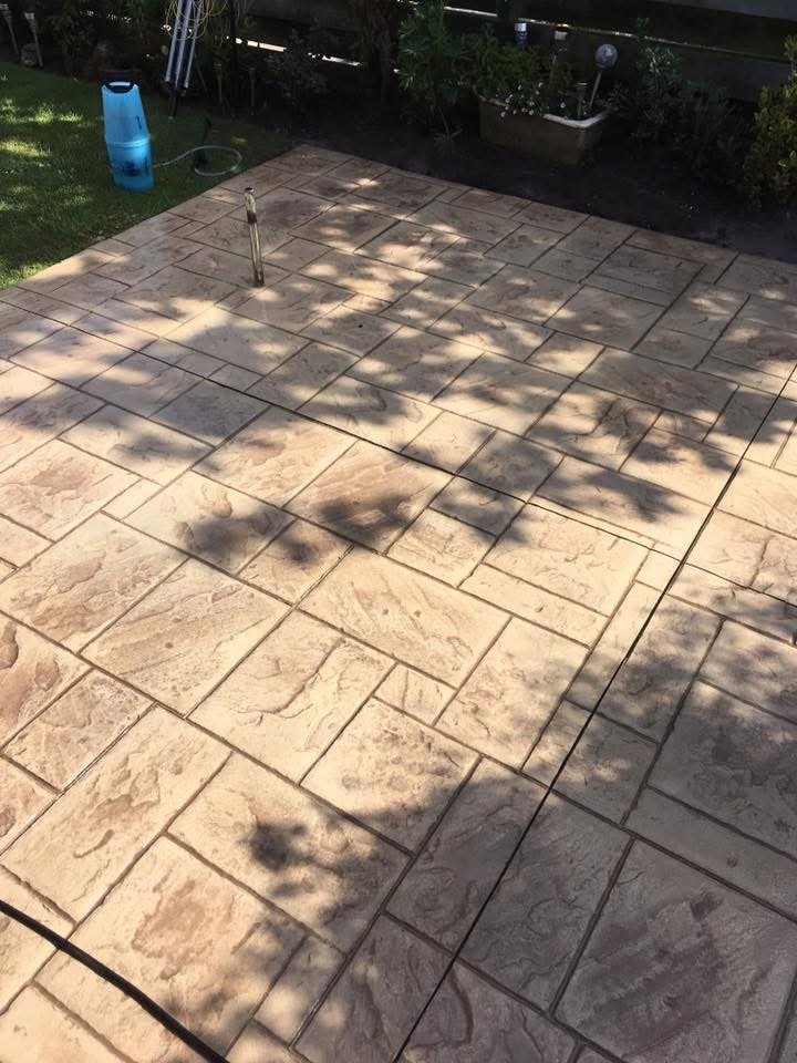 Ashlar slate stamped patio in Essex garden