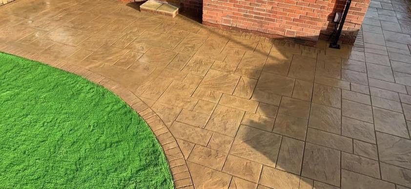Sandstone pattern imprinted driveway with lawn edging
