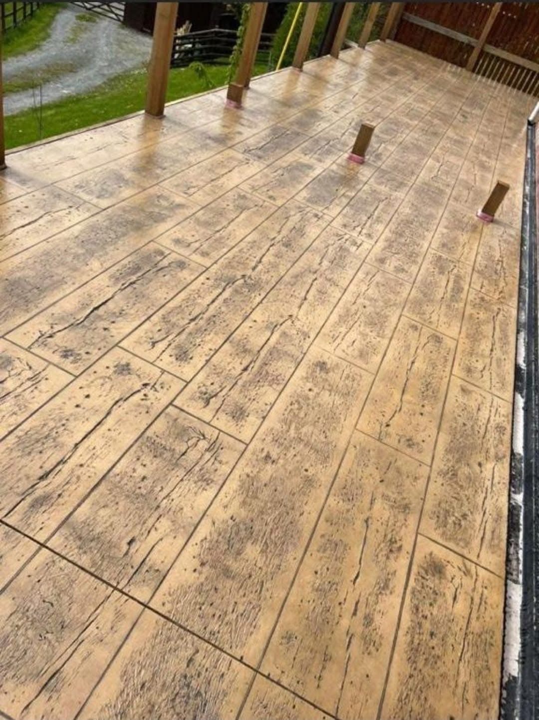 Rustic wood-plank stamped concrete terrace in Essex